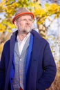 Portrait of man in his 50s in blue suit and coat outdoors Royalty Free Stock Photo