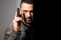 Portrait of a man holding gun. Handsome bearded man. Danger. Gunman with dark background. Serious stylish bearded man Royalty Free Stock Photo