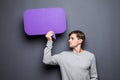 Portrait of Man holding purple blank speech bubble with space for text Royalty Free Stock Photo