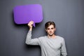 Portrait of Man holding purple blank speech bubble with space for text Royalty Free Stock Photo