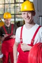 Portrait of a man holding a roll of red cable