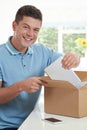 Man At Home Unwrapping Digital Tablet Bought Online