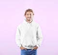 Portrait of man in hoodie sweater on color background Royalty Free Stock Photo