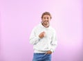 Portrait of man in hoodie sweater on color background Royalty Free Stock Photo