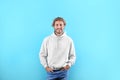 Portrait of man in hoodie sweater on color background Royalty Free Stock Photo