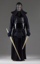 Portrait of man kendo fighter with two bamboo swords in traditional uniform Royalty Free Stock Photo