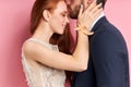 Portrait of man kissing forehead of her woman in wedding dress