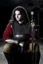 Portrait of Man in Knight Suit With Sword in Old Church Looking Away Royalty Free Stock Photo