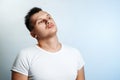 Portrait of a man on a light background close-up. Emotion is the importance, the superiority. The concept of body language, human