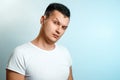 Portrait of a man on a light background close-up. Emotion is the importance, the superiority. The concept of body language, human