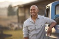 Portrait Of Man Loading Backpack Into Pick Up Truck For Road Trip To Cabin In Countryside Royalty Free Stock Photo