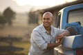 Portrait Of Man Loading Backpack Into Pick Up Truck For Road Trip To Cabin In Countryside Royalty Free Stock Photo