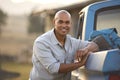 Portrait Of Man Loading Backpack Into Pick Up Truck For Road Trip To Cabin In Countryside Royalty Free Stock Photo