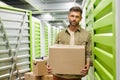 Portrait of Man Loading Boxes in Storage Unit Royalty Free Stock Photo