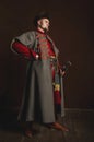 Portrait of a man in a medieval costume on a dark background. Clothes of the Polish gentry