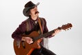 Portrait of man with moustaches in country style clothes playing guitar , singing isolated over white background Royalty Free Stock Photo