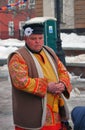 Portrait of a man in national costume standing on the street.