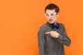 Man nerd pointing away on copy space, discusses amazing promo, gives way or direction. Royalty Free Stock Photo