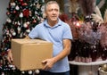 Portrait of man with pasteboard box in christmas market