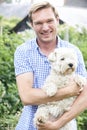 Portrait Of Man With Pet Dog In Garden Royalty Free Stock Photo