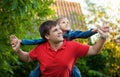 Portrait of man playing with daughter seated on his shoulders Royalty Free Stock Photo