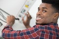 portrait man plugging power cable into electrical device