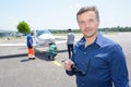 Portrait man on runway with light aircraft Royalty Free Stock Photo