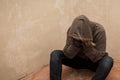 Portrait of man sad, drug addict man sitting on the floor in corner Royalty Free Stock Photo