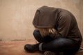 Portrait of man sad, drug addict man sitting on the floor in corner Royalty Free Stock Photo