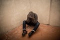 Portrait of man sad, drug addict man sitting on the floor in corner Royalty Free Stock Photo