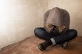 Portrait of man sad, drug addict man sitting on the floor in corner Royalty Free Stock Photo