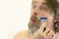 Portrait of man shaving. A variety of emotions. Cruelty and masculinity.