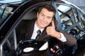 Portrait of man sitting in new car showing thumbs up Royalty Free Stock Photo