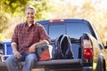 Portrait Of Man Sitting In Pick Up Truck On Camping Holiday Royalty Free Stock Photo