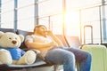 Portrait of man sleeping and lying on chair while waiting for his flight in airport Royalty Free Stock Photo