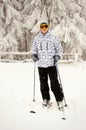 Portrait of a man standing on skis and posing against snowy mountains and forests. Winter nature in the mountains of the Royalty Free Stock Photo