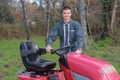 Portrait man stood beside mower Royalty Free Stock Photo