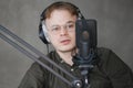 portrait of man in studio is recording podcast, audio content of interview on radio. Caucasian male Royalty Free Stock Photo