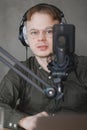 portrait of man in studio is recording podcast, audio content of interview on radio. Caucasian male Royalty Free Stock Photo