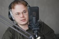 portrait of man in studio is recording podcast, audio content of interview on radio. Caucasian male Royalty Free Stock Photo