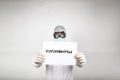 Portrait of man in surgical mask wearing white protective suit and a sign with the word coronavirus isolated in studio on white Royalty Free Stock Photo