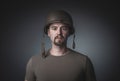 Portrait of a man in a t-shirt wearing a soldier`s military helmet Royalty Free Stock Photo