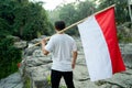 Asian male with indonesian flag celebrating independence day Royalty Free Stock Photo