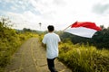 Asian male with indonesian flag celebrating independence day Royalty Free Stock Photo