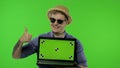 Portrait of man tourist in sunglasses showing laptop. Thumbs up. Chroma key Royalty Free Stock Photo