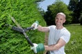 Portrait man trimming hedge with shears Royalty Free Stock Photo