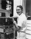 Portrait of man tying down luggage