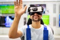 Portrait of man using virtual reality headset at exhibition show. VR technology simulation concept