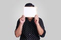 Young Asian Man Covering His Face With Small Whiteboard Royalty Free Stock Photo