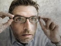 Portrait of man wearing glasses in shock and surprise face expression. guy opening eyes wide looking or reading something amazing Royalty Free Stock Photo